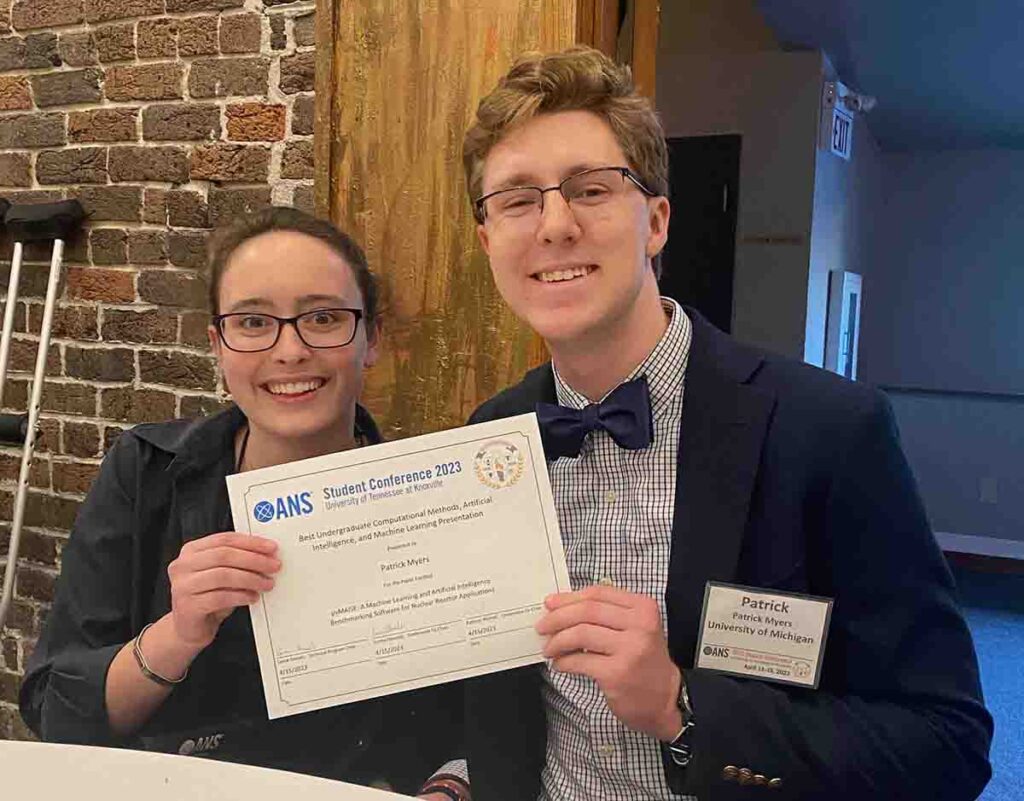 two people holding a paper award