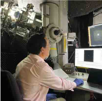 man siting in front of computer screen and machinery 