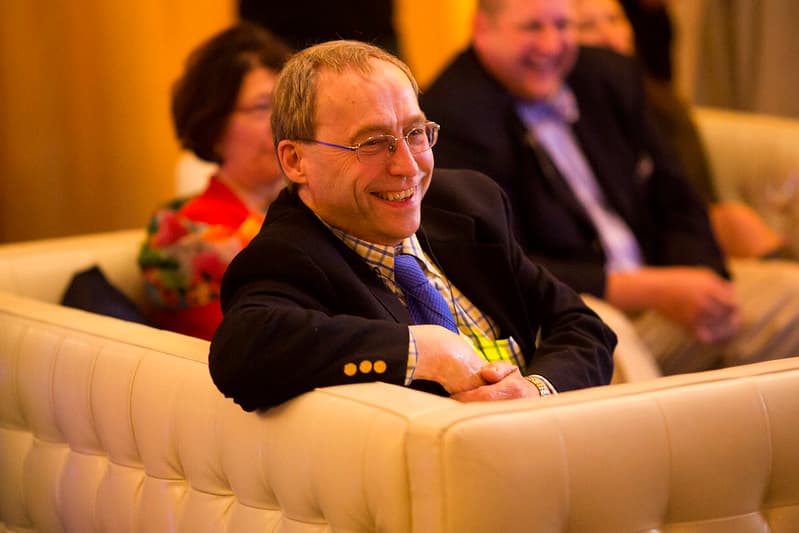 Ron Gilgenbach smiling in a chair