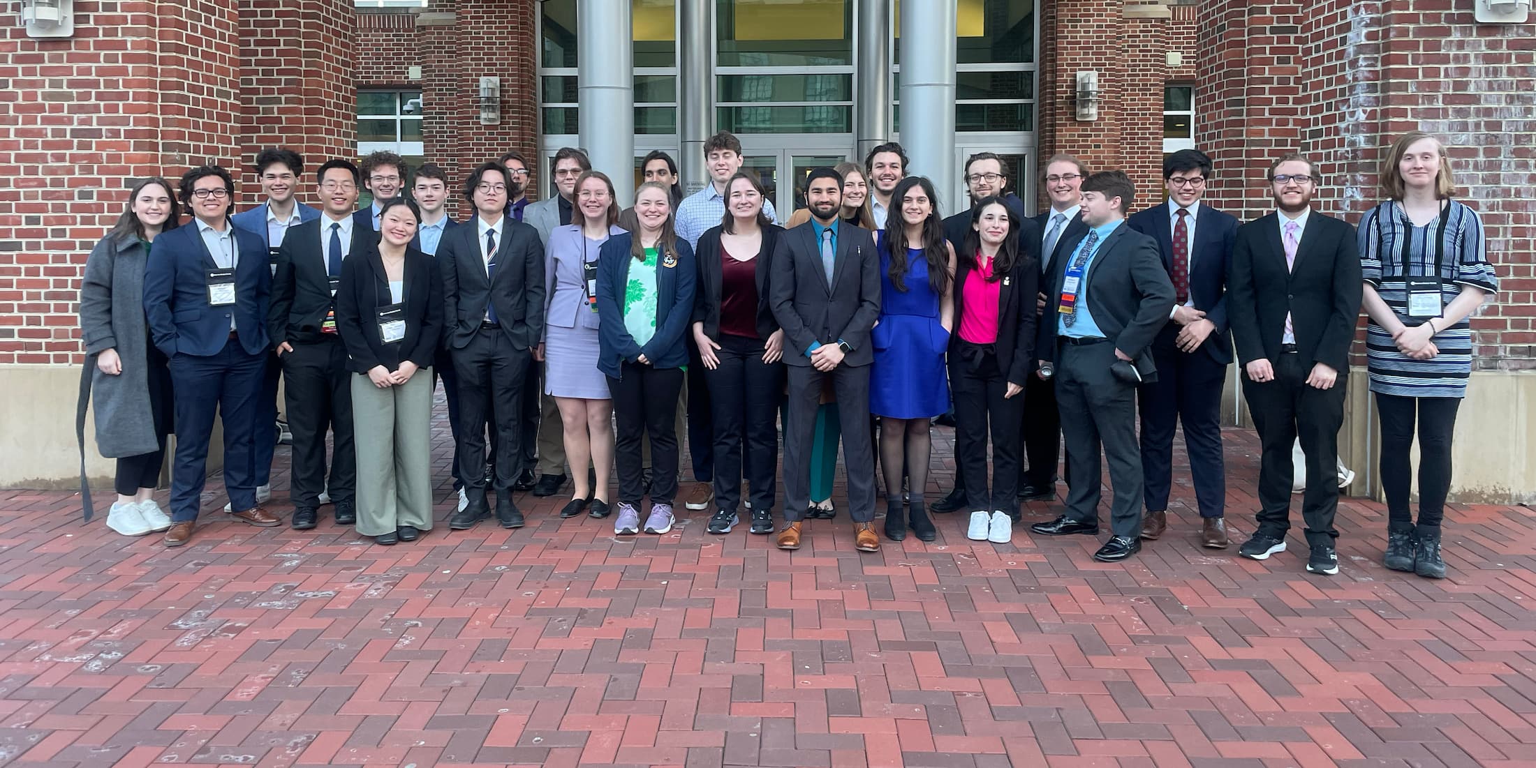 30 students standing in front of building entryway