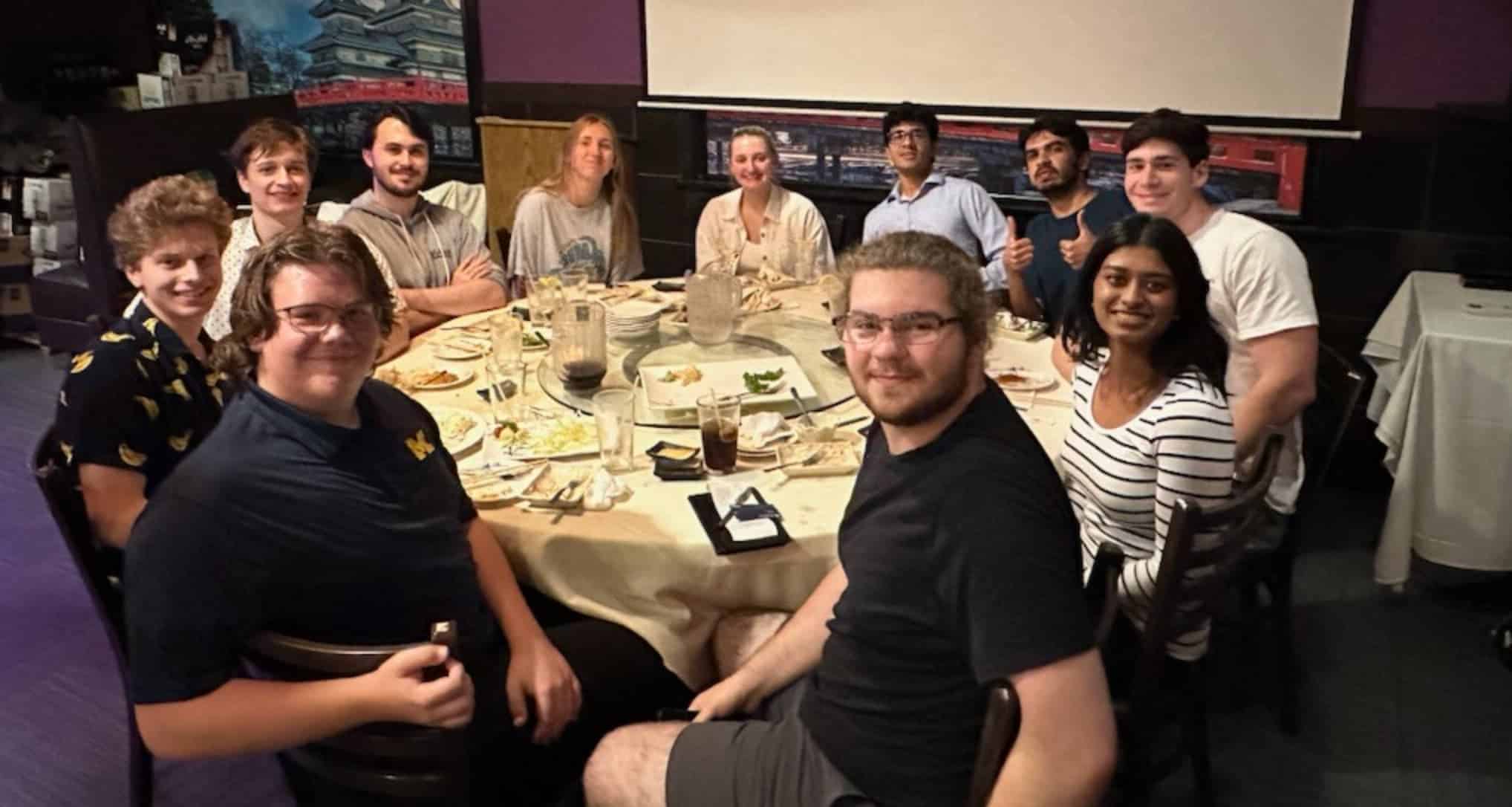 a group of students sitting around a table